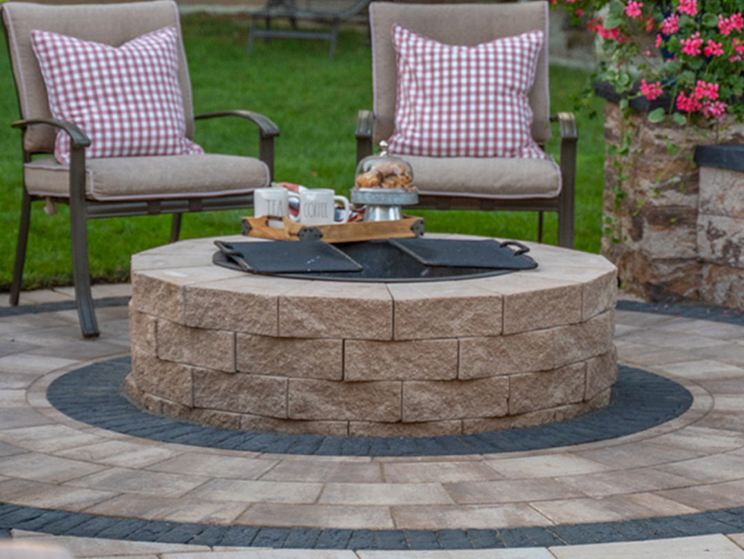 Affordable patio A paver fire pit patio creates an inviting space for gatherings, surrounded by built-in bench seating.