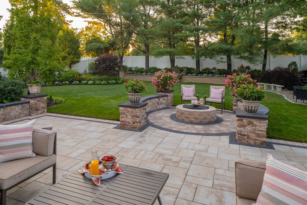 Modern home patio company, patio lovers, A flagstone walkway leads to a charming gazebo, surrounded by colorful flowers and greenery.