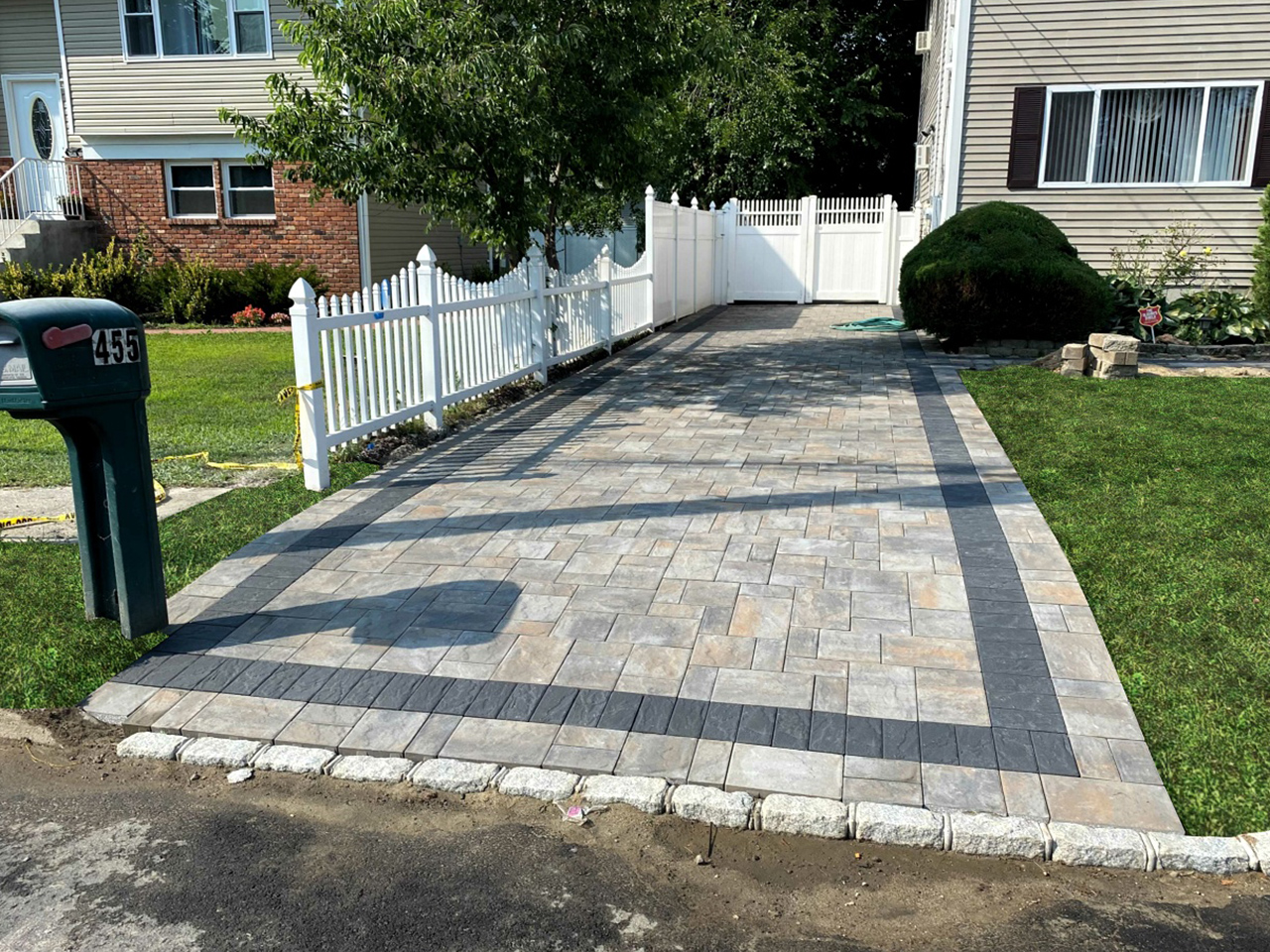 A stunning driveway project by Affordable Patio, blending seamlessly with the surrounding landscape