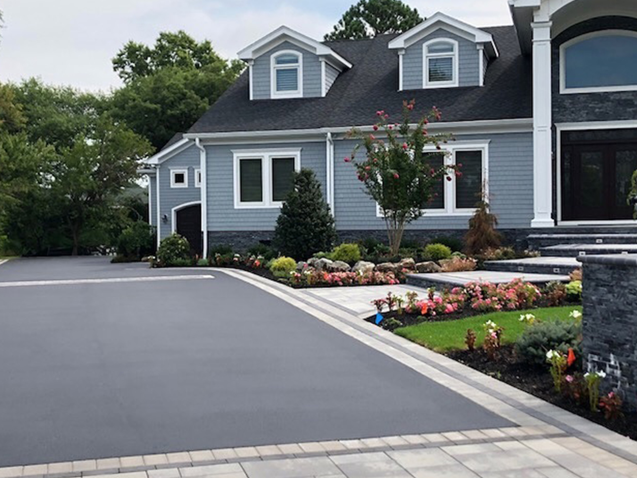 A beautifully paved driveway by Affordable Patio, showcasing a sleek and durable surface
