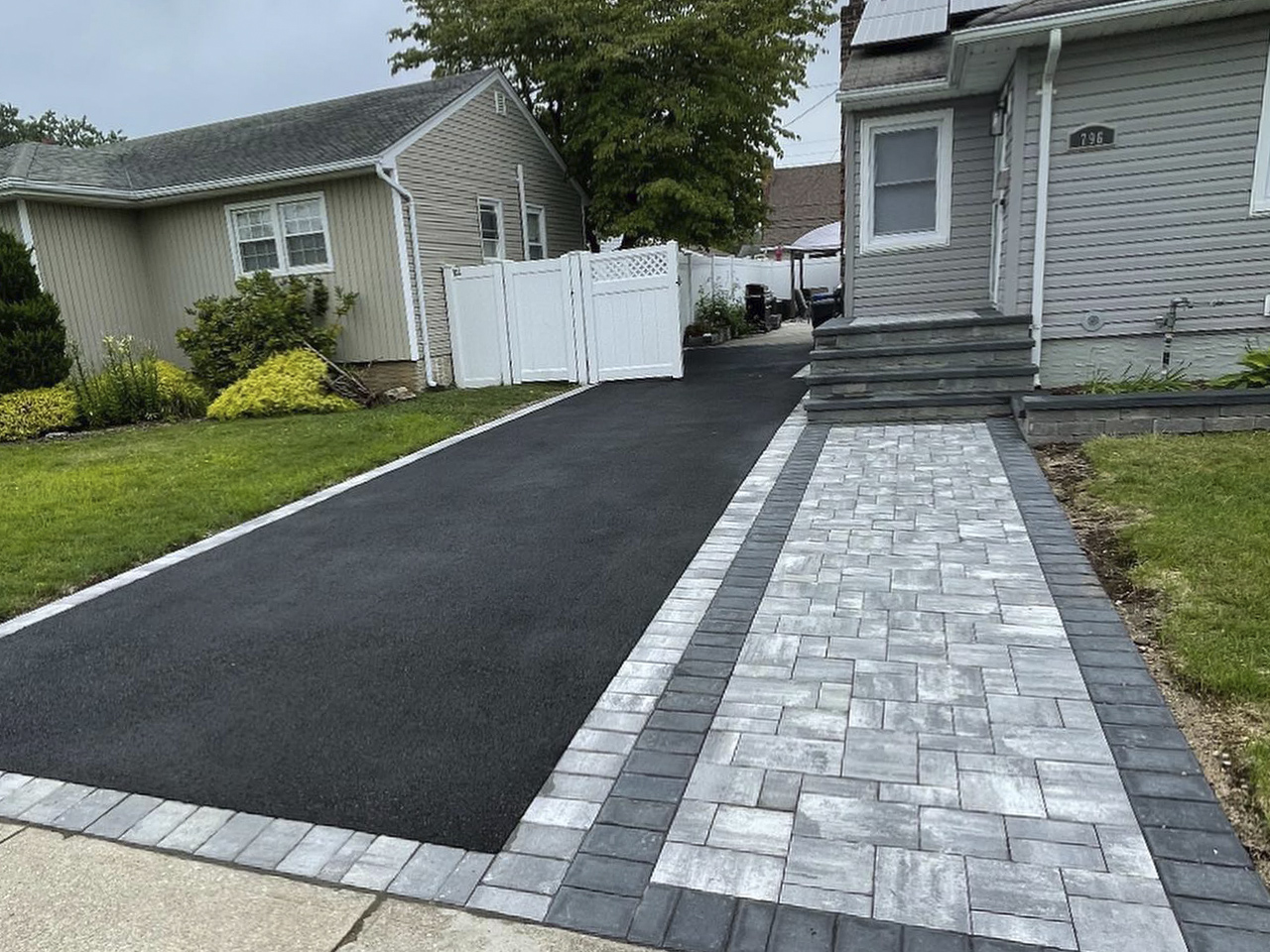 A beautifully paved driveway by Affordable Patio, featuring a smooth surface and precise craftsmanship