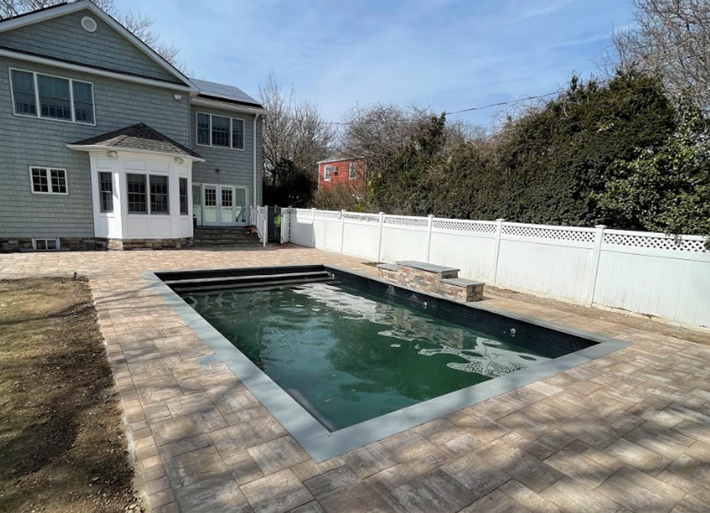 patio ideas for Holbrook, front yard walkways ideas, front yard driveway ideas, A paver patio features a built-in barbecue grill and outdoor kitchen, perfect for hosting summer parties.