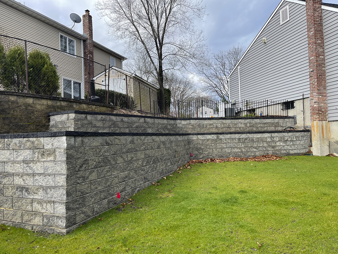 Inexpensive concrete block retaining wall next to a patio