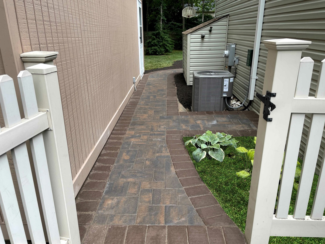 paver walkway installation. Impeccable craftsmanship on display in this finished patio walkway by Affordable Patio, with attention to detail in every step