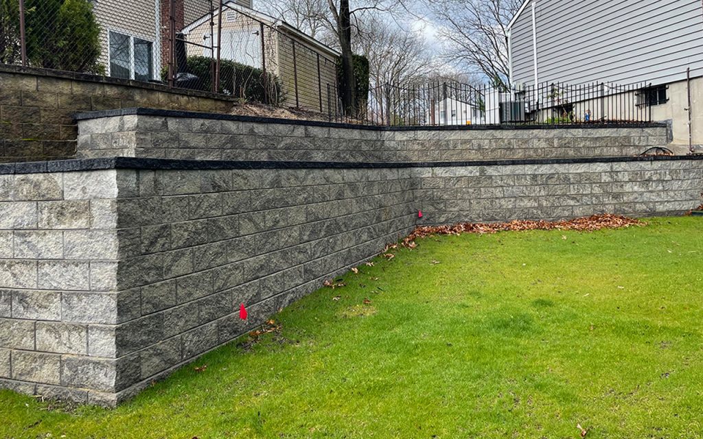 Low-cost stone retaining wall surrounding a patio