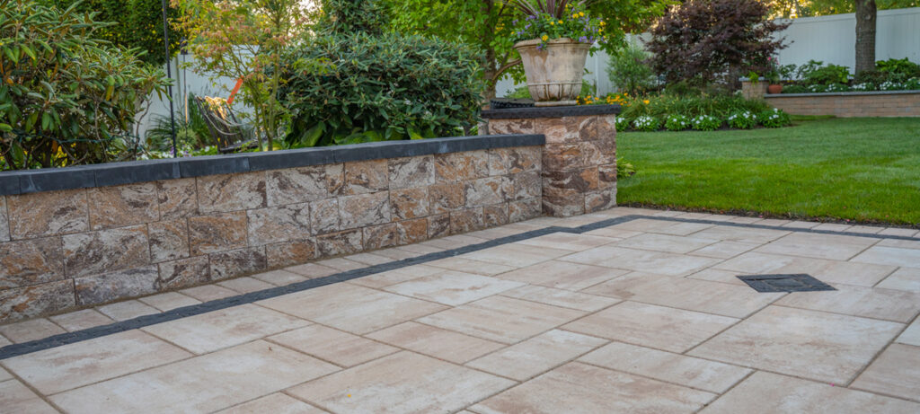 Professional patio installer laying high-quality pavers in a Long Island backyard