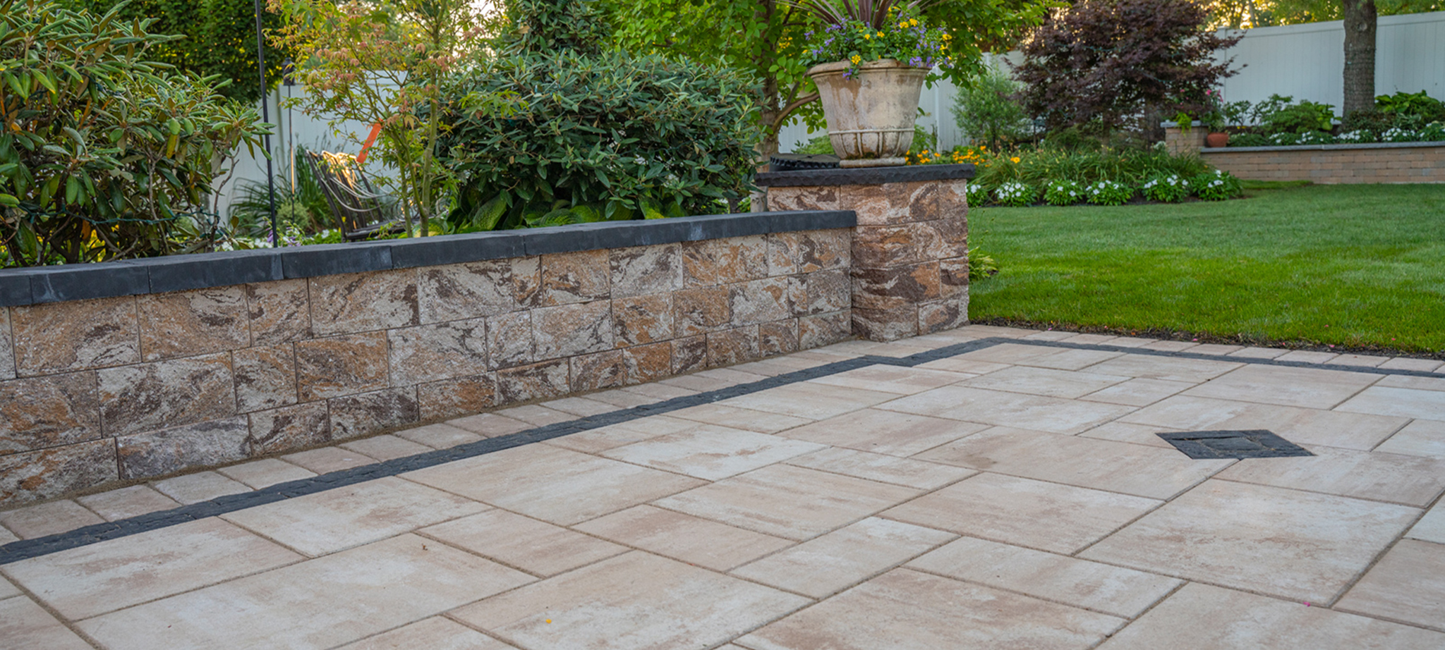 Professional patio installer laying high-quality pavers in a Long Island backyard