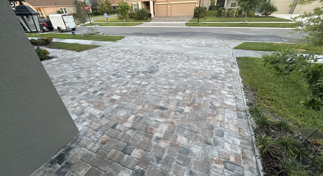Close-up view of a newly installed paver driveway with a rustic color blend, highlighting texture and quality from the best pavers for driveways