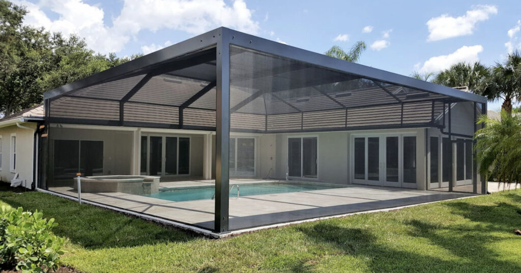 Modern backyard pool with full aluminum enclosure and screen walls installed during a professional pool screen installation in Florida.