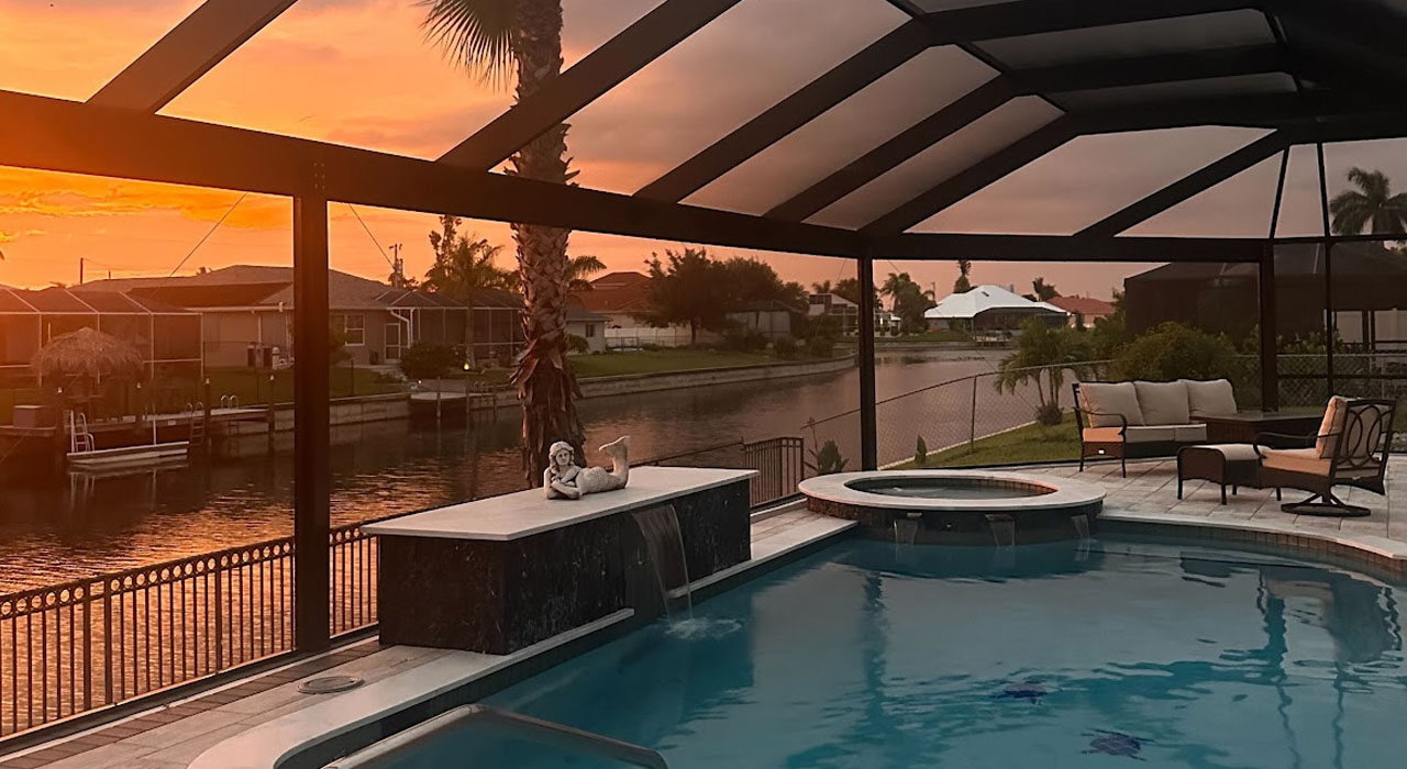 Modern backyard pool with full aluminum enclosure and screen walls installed during a professional pool screen installation in Florida.