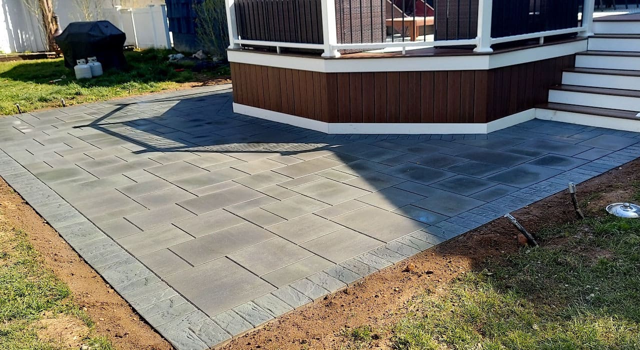 Modern gray patio with sharp paver lines and fresh surface finish, demonstrating results from proper techniques on how to clean patio pavers