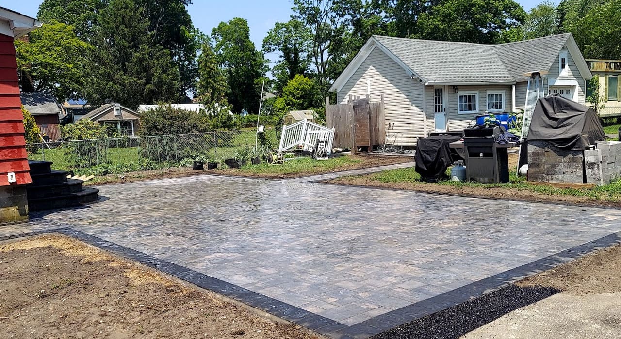 Residential paver patio installation with a newly washed surface, illustrating how to clean patio pavers for long-lasting color and durability