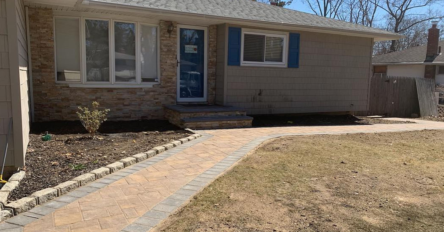 Front walkway and paver stoop designed to match the home’s exterior, built to standard sizes for walkways, stoops, and 2-car driveways in Suffolk County.