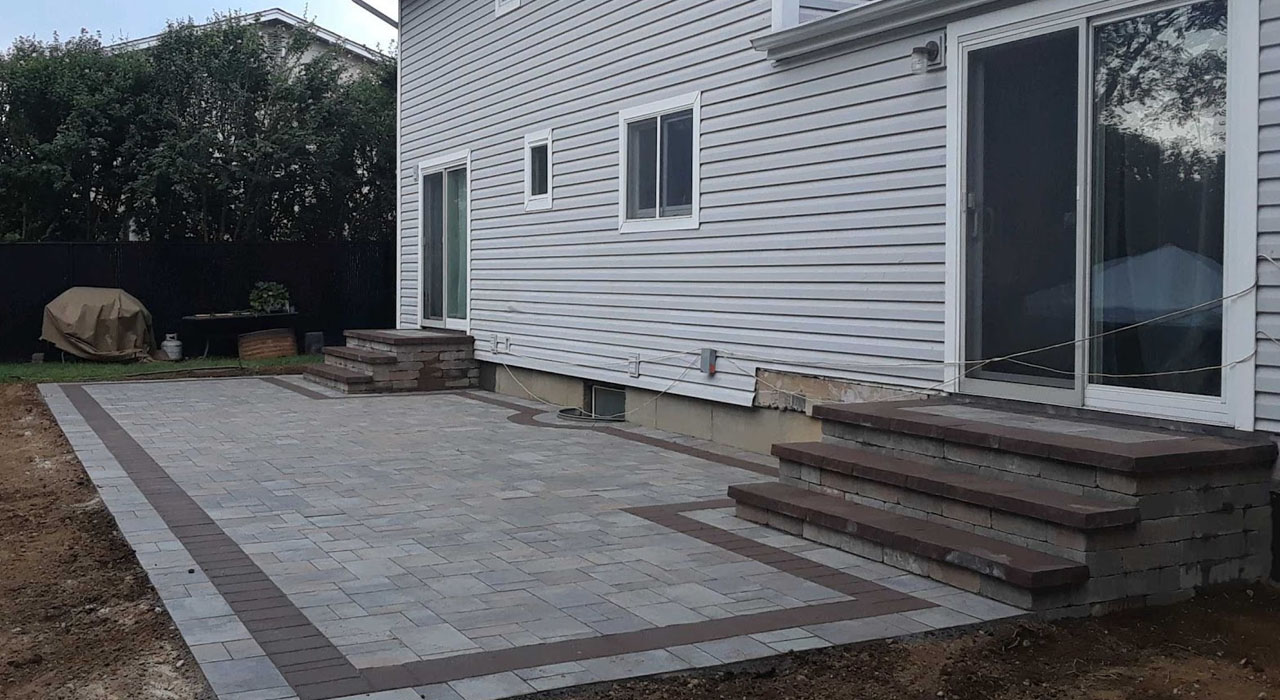 Custom patio and matching paver stoops showing balanced layout and spacing that follow standard sizes for walkways, stoops, and 2-car driveways.