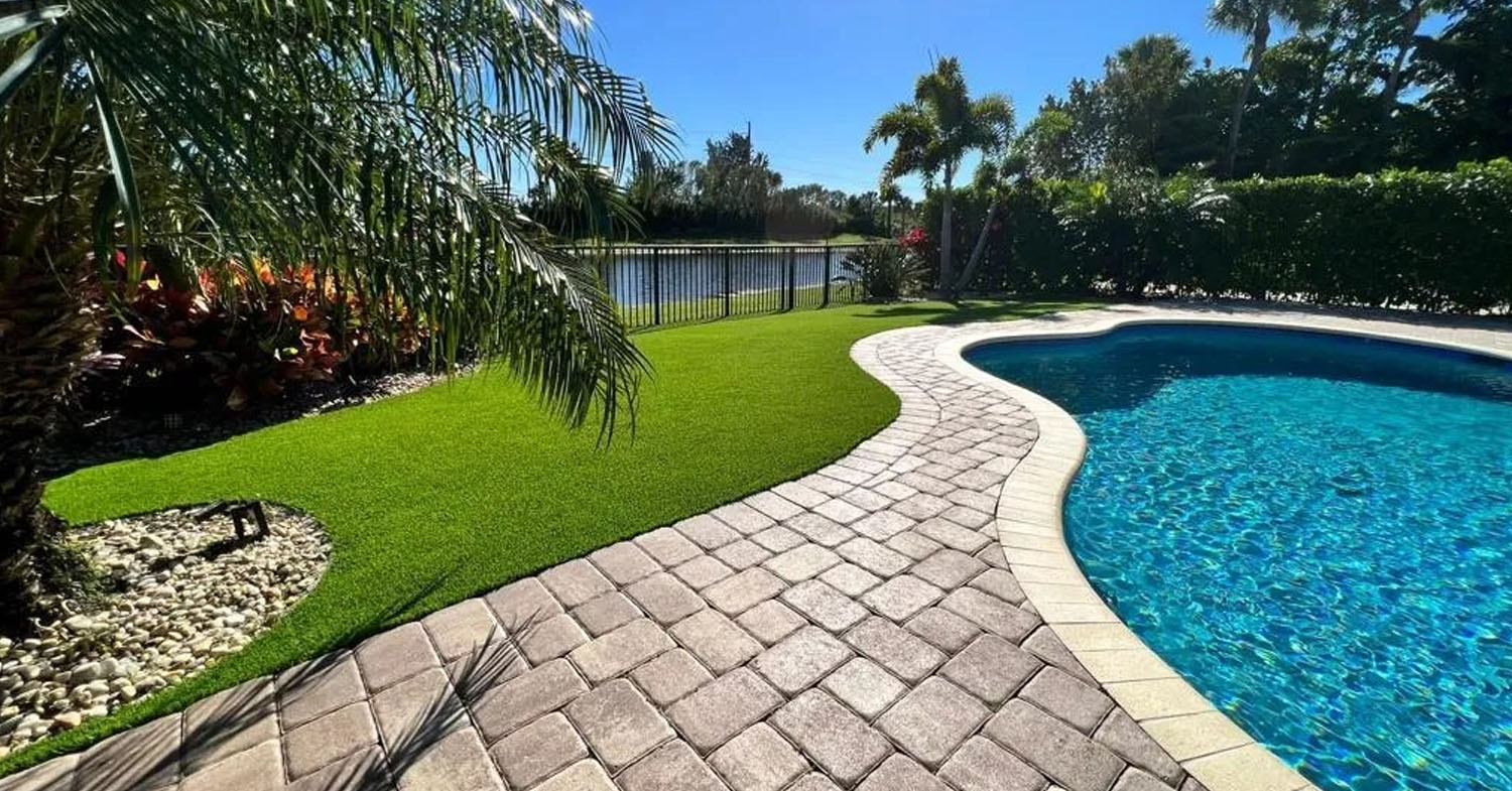 Luxury outdoor living space featuring pool, spa, seating area, and custom lanai enclosure overlooking canal.