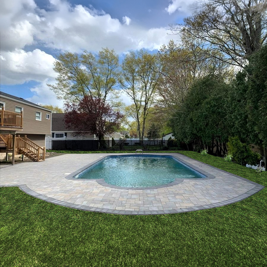 Travertine-style pool deck pavers in warm sand tones, providing a smooth, heat-resistant surface for a luxury backyard.