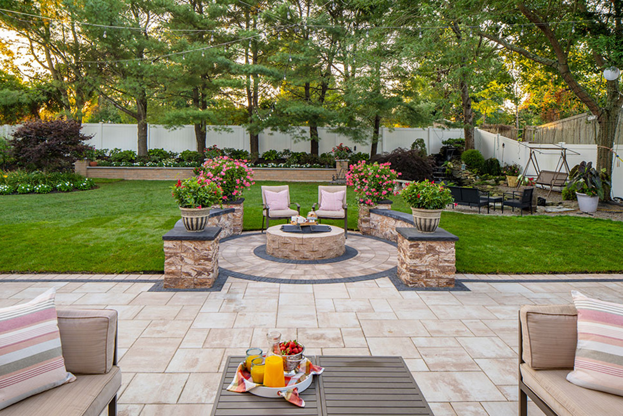 Slip-resistant bluestone walkway with integrated low-voltage lighting for enhanced safety and curb appeal in a front yard.