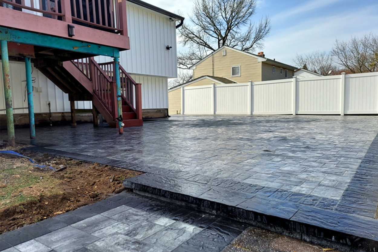Permeable paver driveway with a classic herringbone pattern, designed for superior drainage during Long Island winters.
