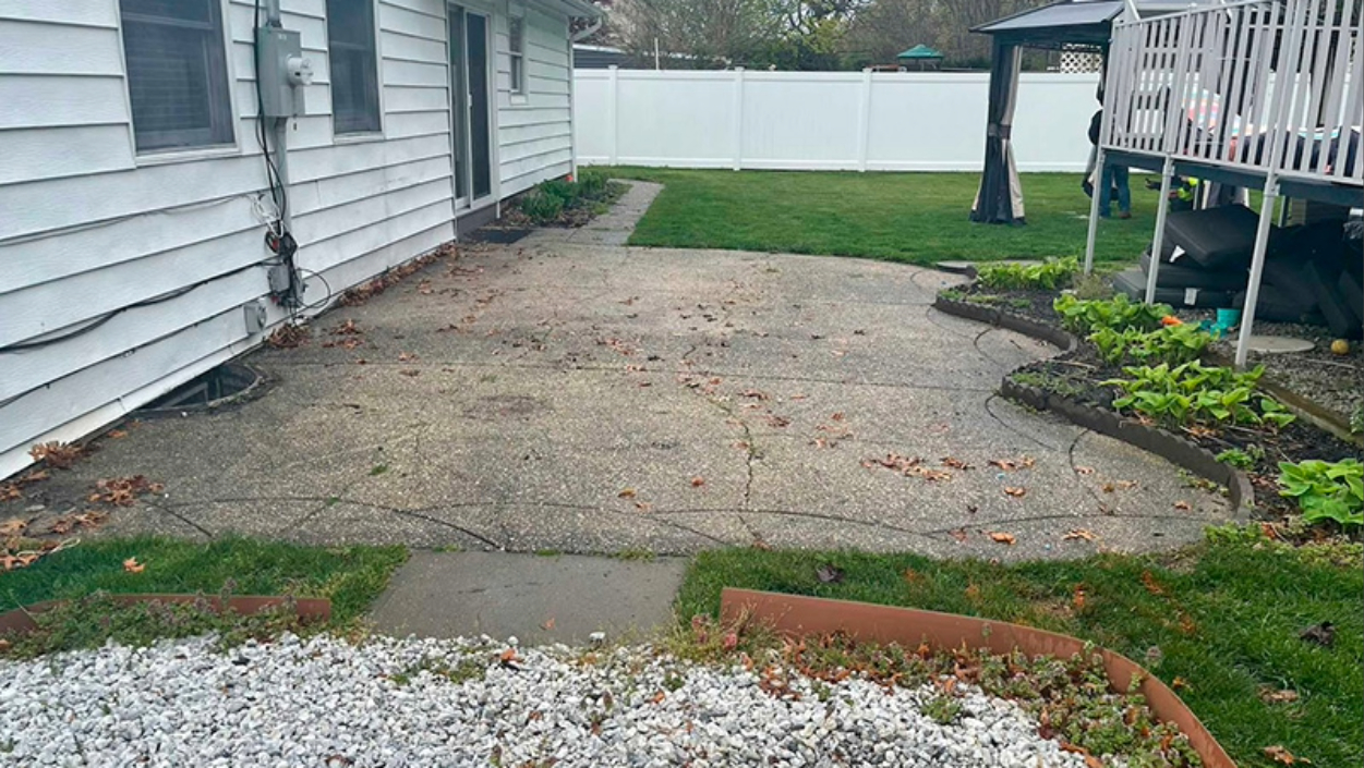 Old, cracked concrete patio in need of repair or replacement.