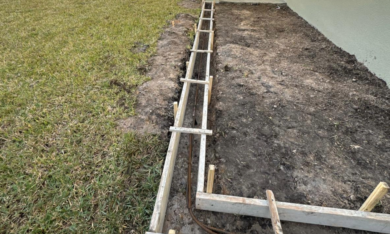 The early framing stage of a professional concrete Patio Installation for a Florida home.