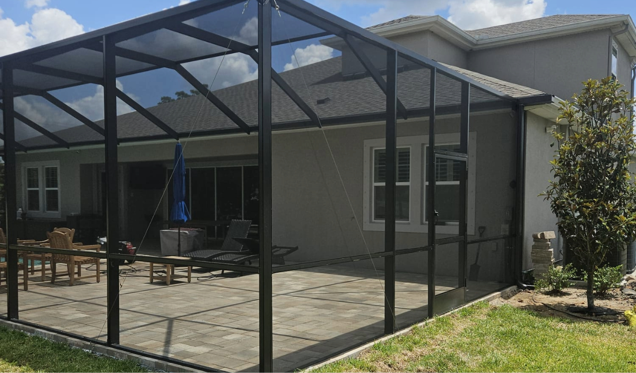 Screened-in stone patio. Improve your backyard view with a quick lanai screen door replacement.