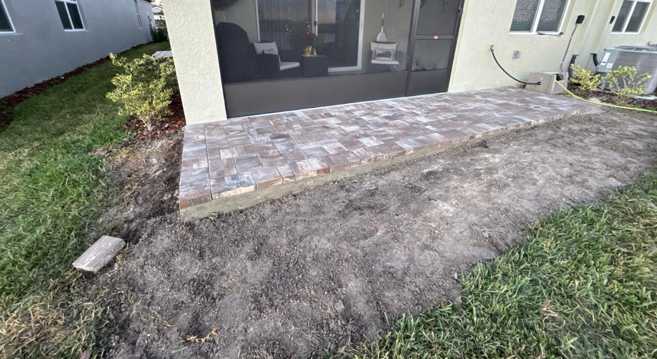 Newly installed brown pavers in a screen lanai. Simple tips on how to stop weeds between pavers.