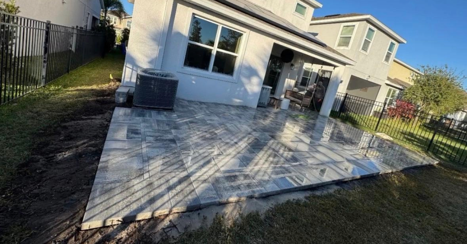 A new grey paver patio installation. Learn how to stop weeds between pavers for lasting results.