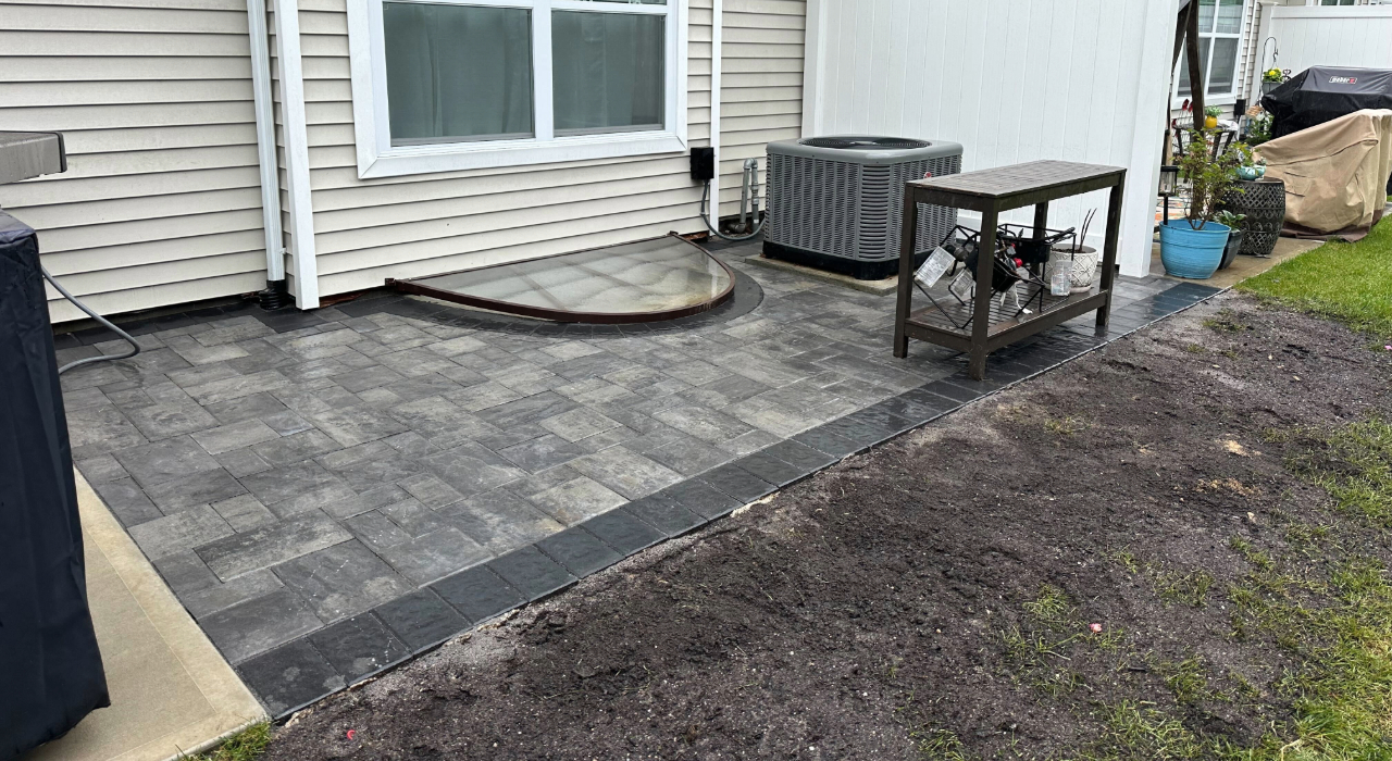 A premium backyard lounge featuring high-end stone textures, showcasing the design possibilities of Cambridge Pavers vs Nicolock.
