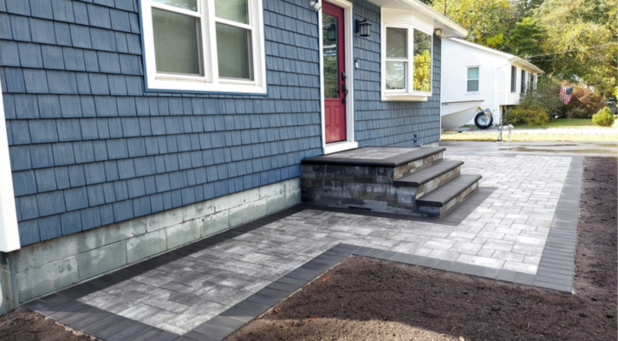 A newly constructed stone entrance with masonry steps, an excellent example of functional outdoor living space ideas.