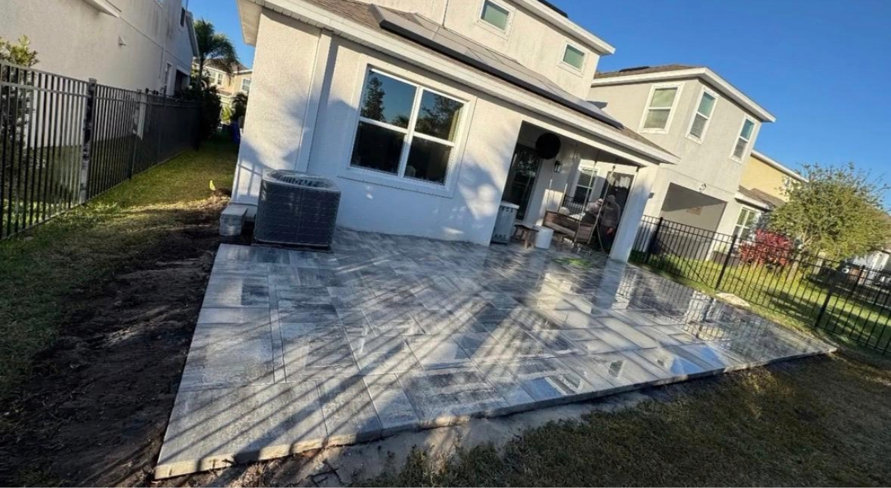 A completed backyard stone layout featuring integrated retaining walls, a premium feature in the average cost of a paver patio.
