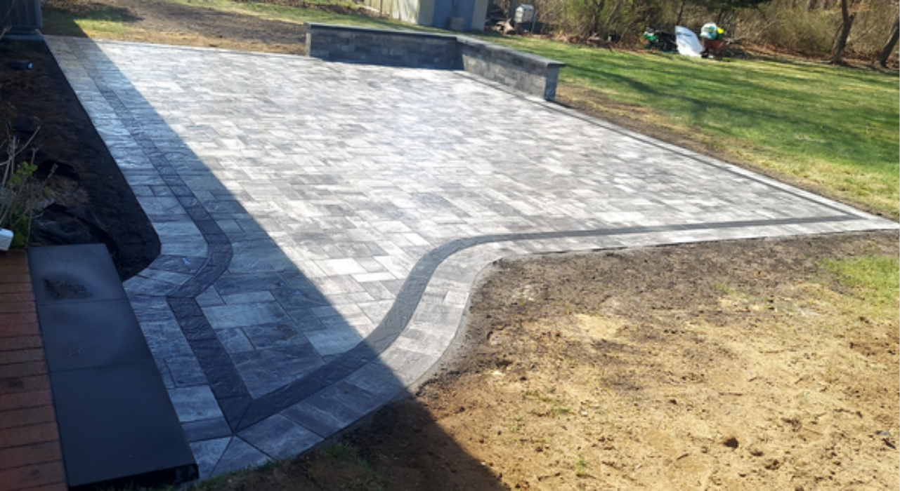 Close-up of interlocking earth-tone pavers, demonstrating the aesthetic and structural benefits in the concrete vs paver patio debate.