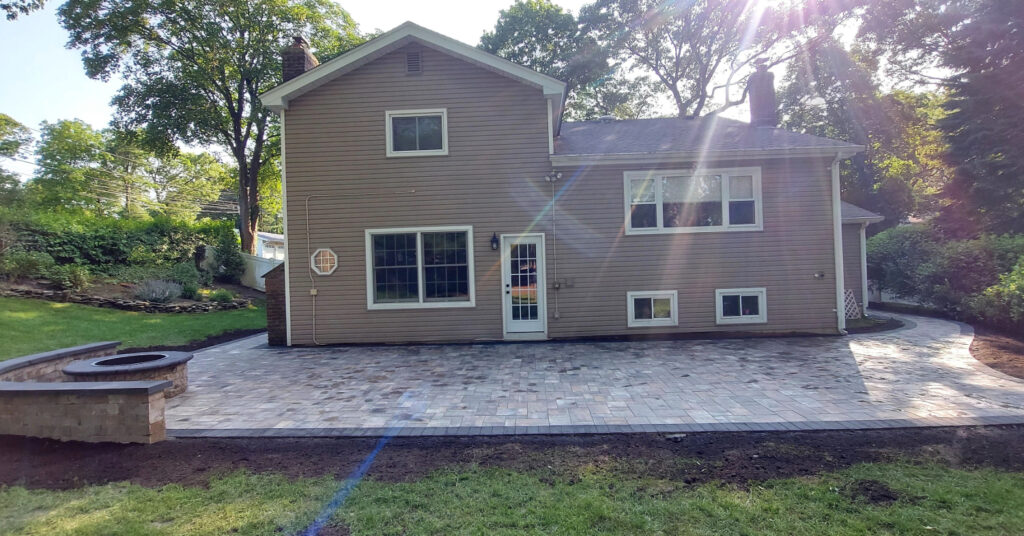 A final layer of concrete sand being screeded over gravel to complete the essential patio paver base setup.