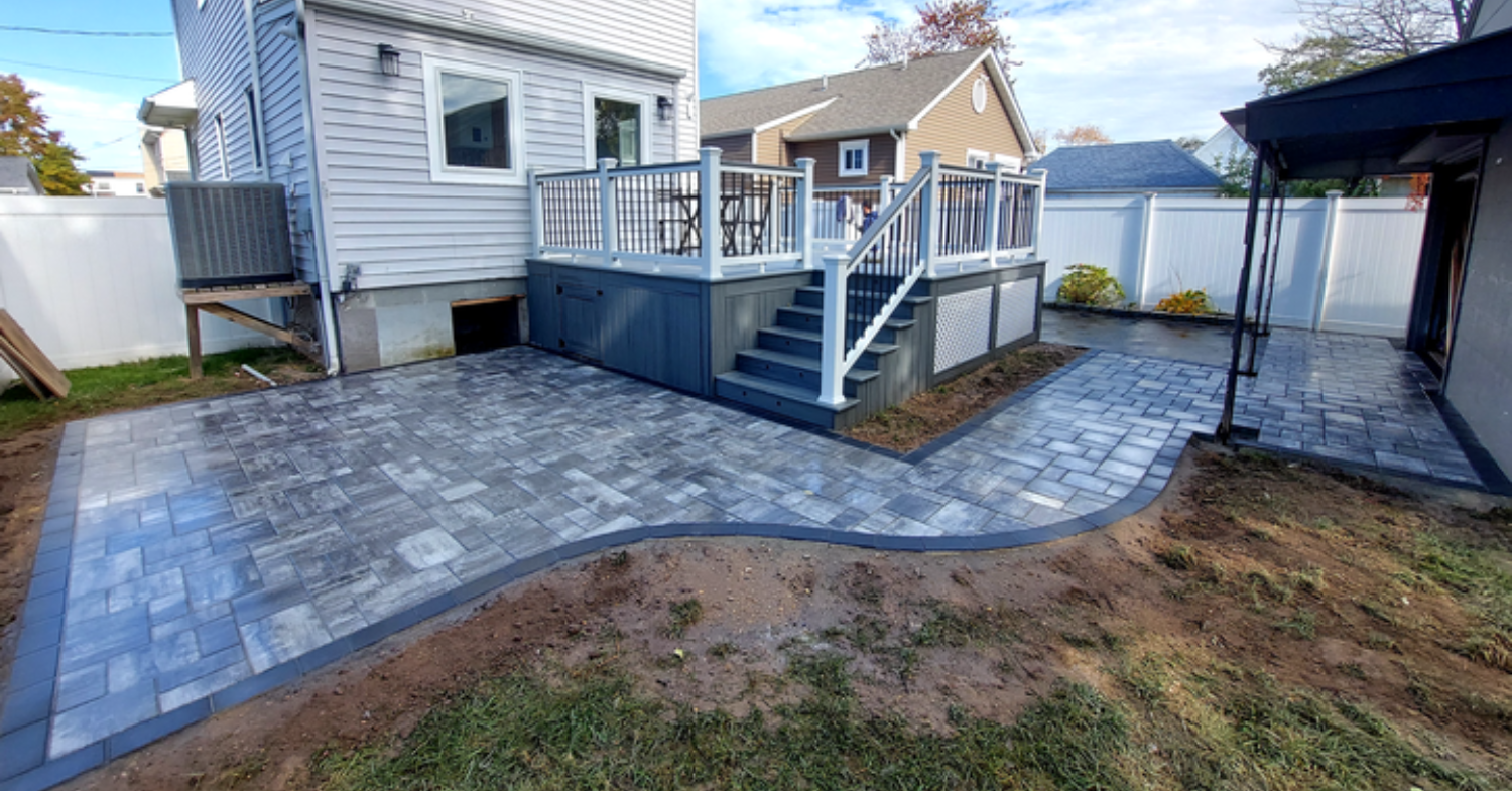 A cozy circular stone paver layout with a bistro set, providing inspiration for functional small patio design ideas.