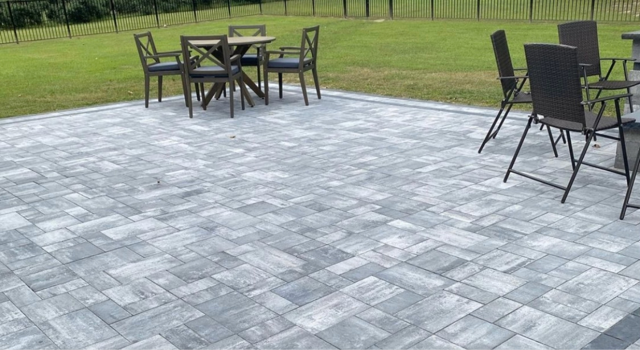 A tiered stone patio that maximizes vertical space in a backyard, showcasing innovative small patio design ideas for homes.