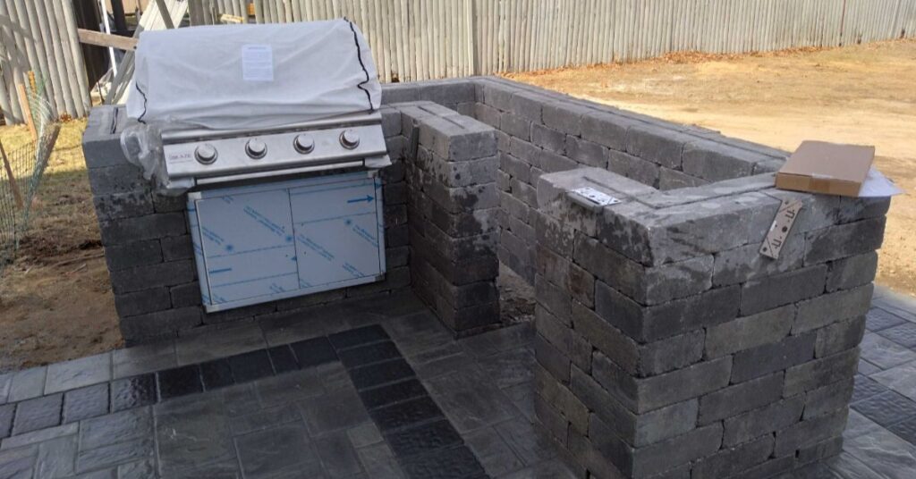 outdoor kitchen installation planning for a Suffolk County patio with grill, counter space, seating, and paver layout