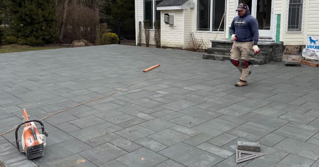 outdoor living space contractor planning a Suffolk County backyard with patio, fire pit, outdoor kitchen, and wall zones