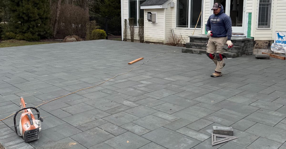 outdoor living space contractor planning a Suffolk County backyard with patio, fire pit, outdoor kitchen, and wall zones