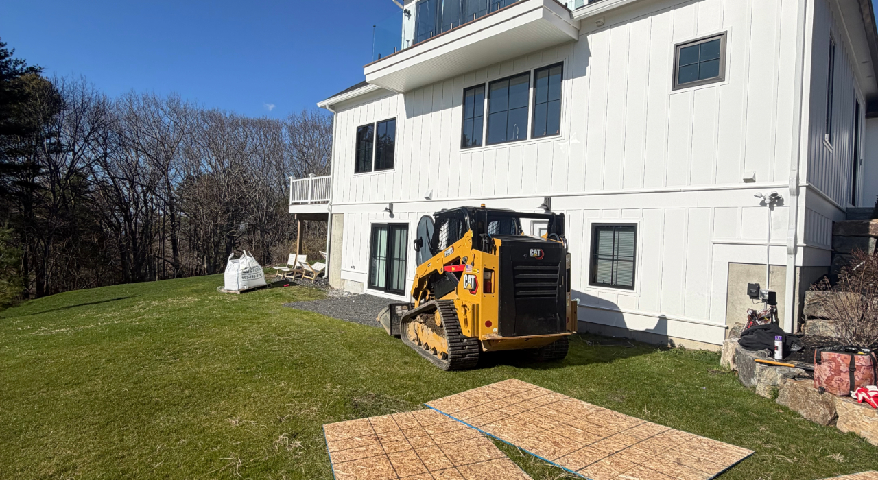 Looking out over a freshly installed grey patio highlights the precise work a professional paver patio contractor in Manchester provides.