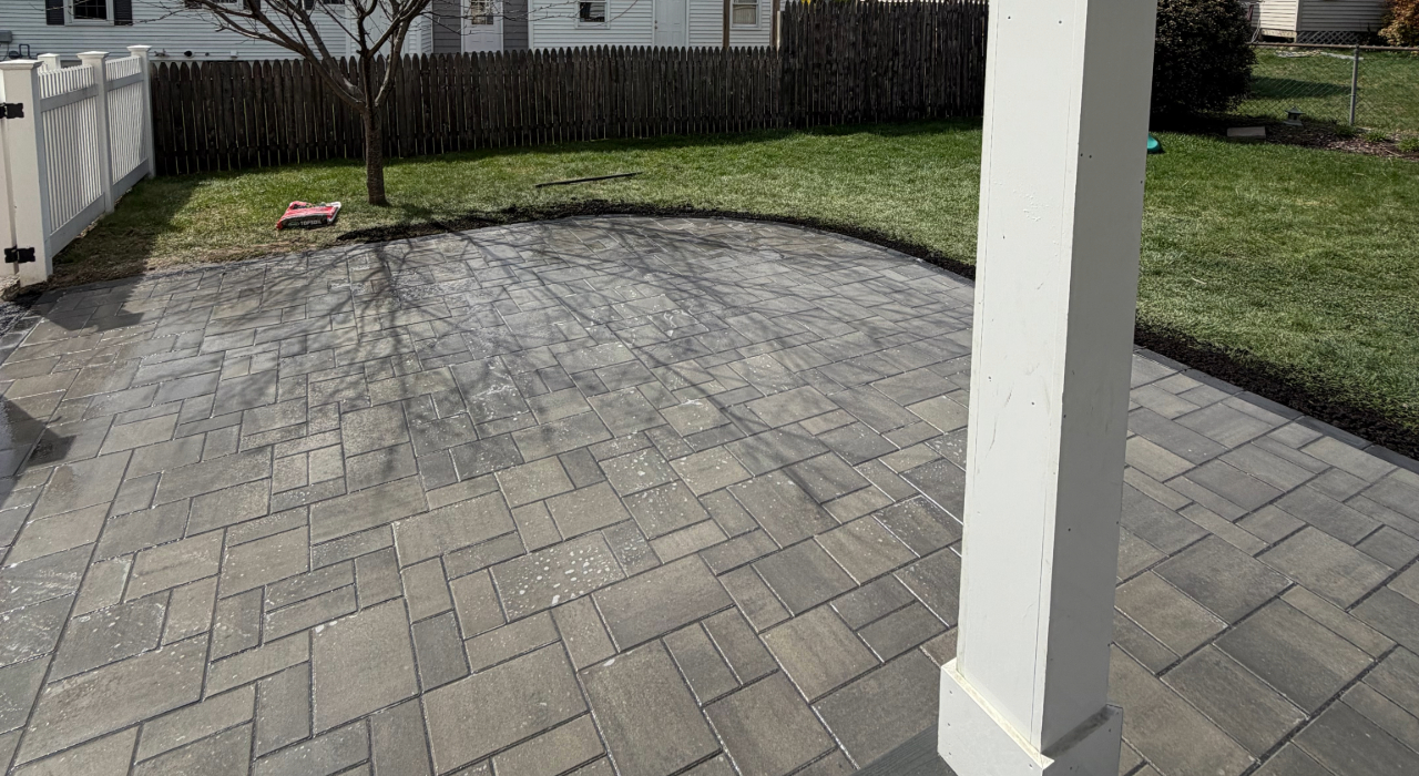 Viewing this large newly installed grey stone surface helps homeowners visualize the average paver patio cost in Manchester for properties.