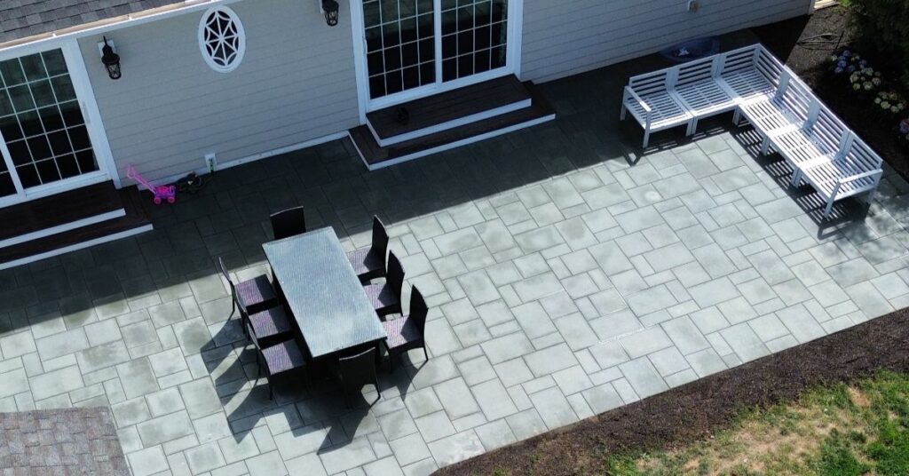 Paver patio installation in Suffolk County backyard with fresh pavers, clean edges, and proper drainage planning