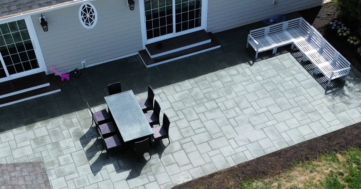 Paver patio installation in Suffolk County backyard with fresh pavers, clean edges, and proper drainage planning