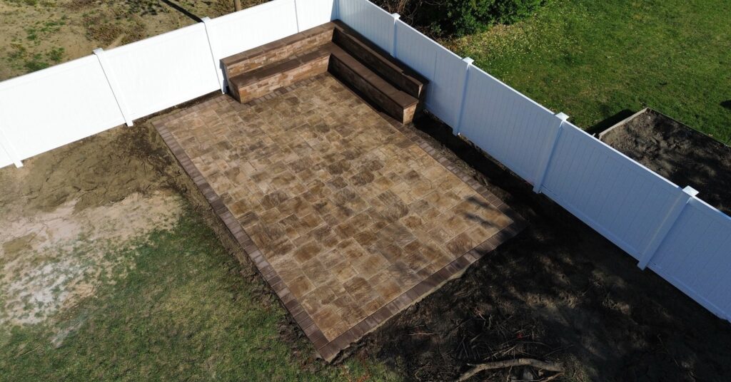 Patio ideas Long Island backyard with paver dining area, seating, and clean outdoor layout