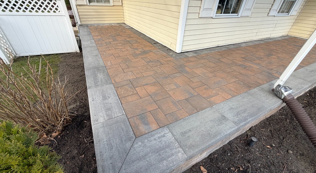Backyard patio ideas with paver border, outdoor seating, poolside walkway, and Long Island home design
