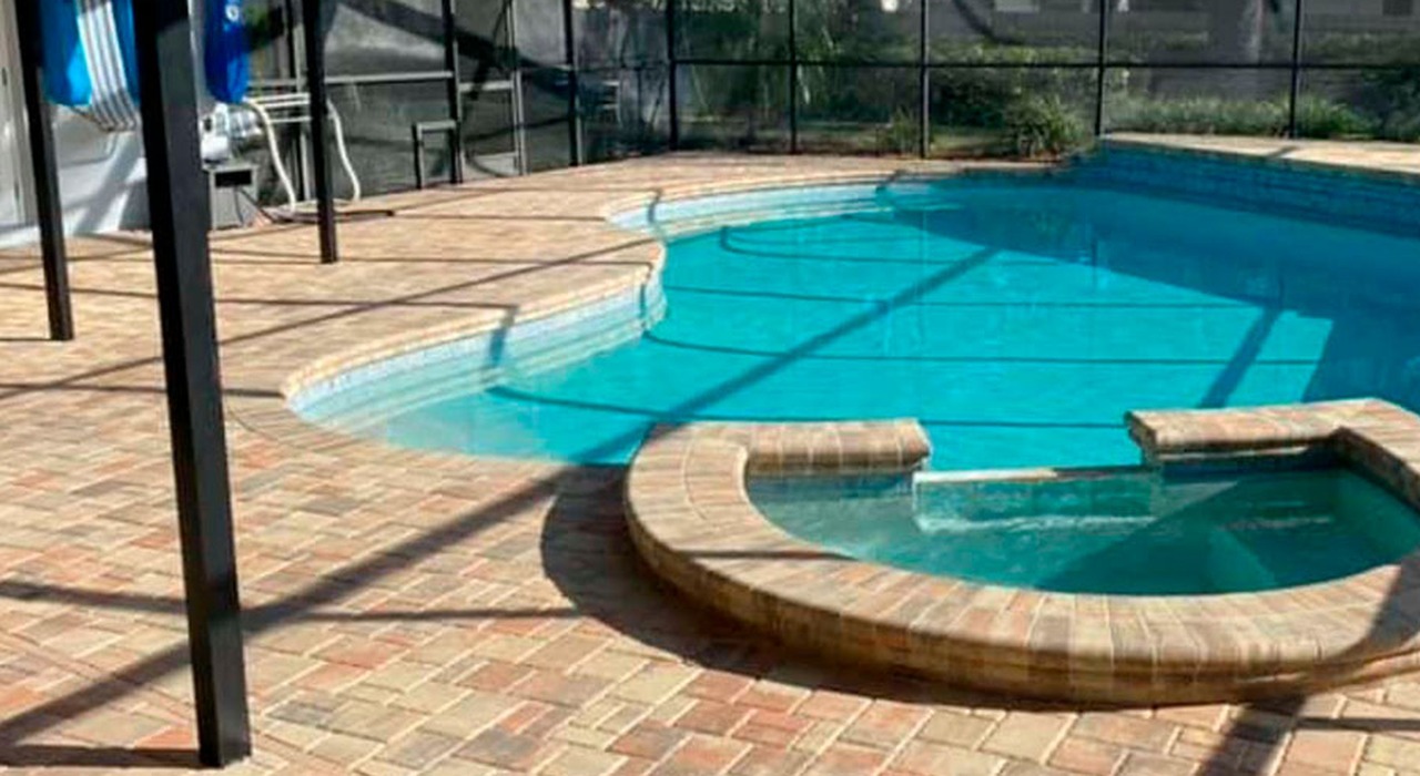 A custom swimming pool and spa cage structure presenting budget friendly lanai enclosure options