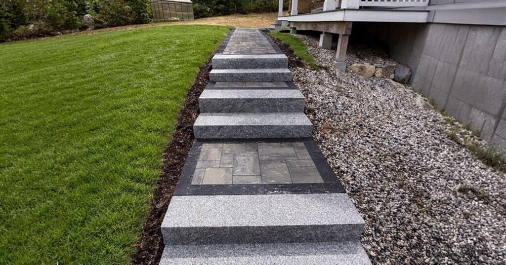 Beautiful finished stone walkway representing high-quality granite steps installation in Nashua