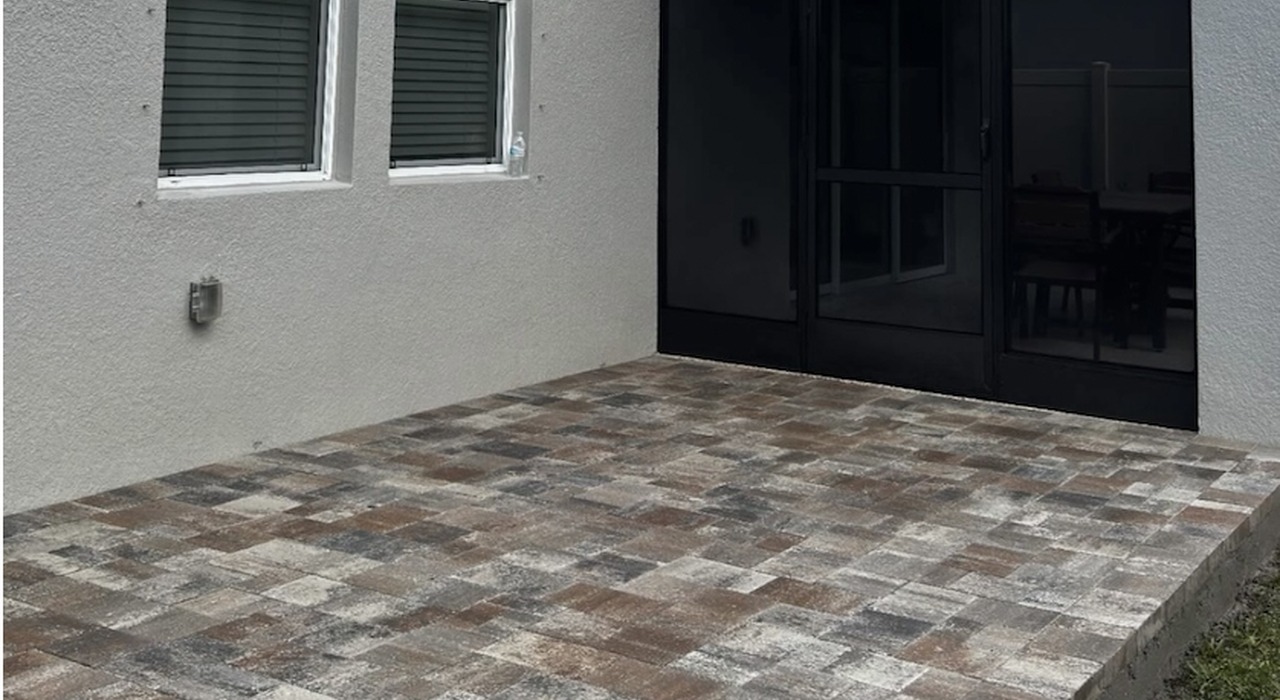 Brown textured stone backyard entryway, showing how much does a paver patio cost.