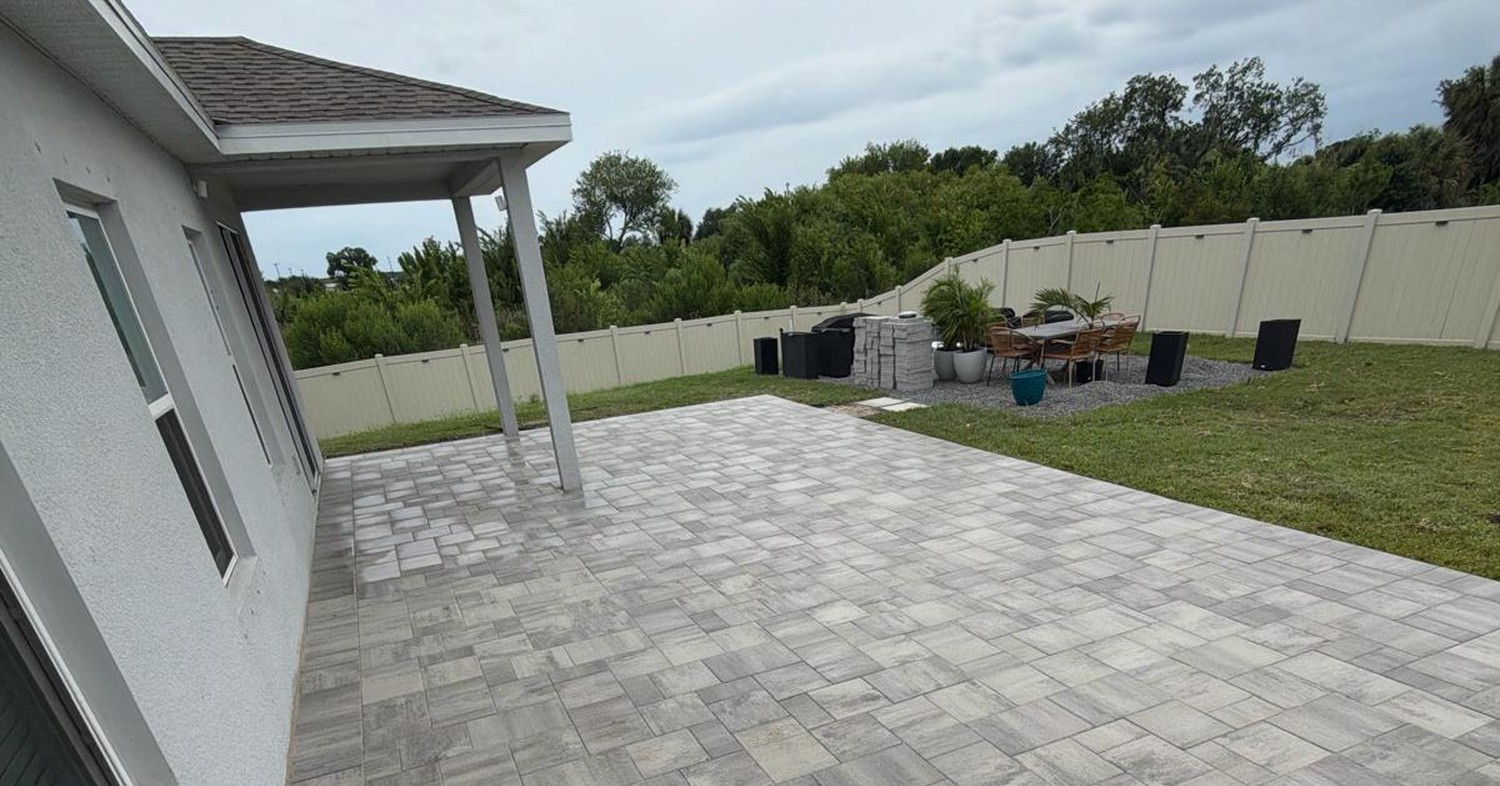 Newly installed gray backyard stones showing how much does a paver patio cost.