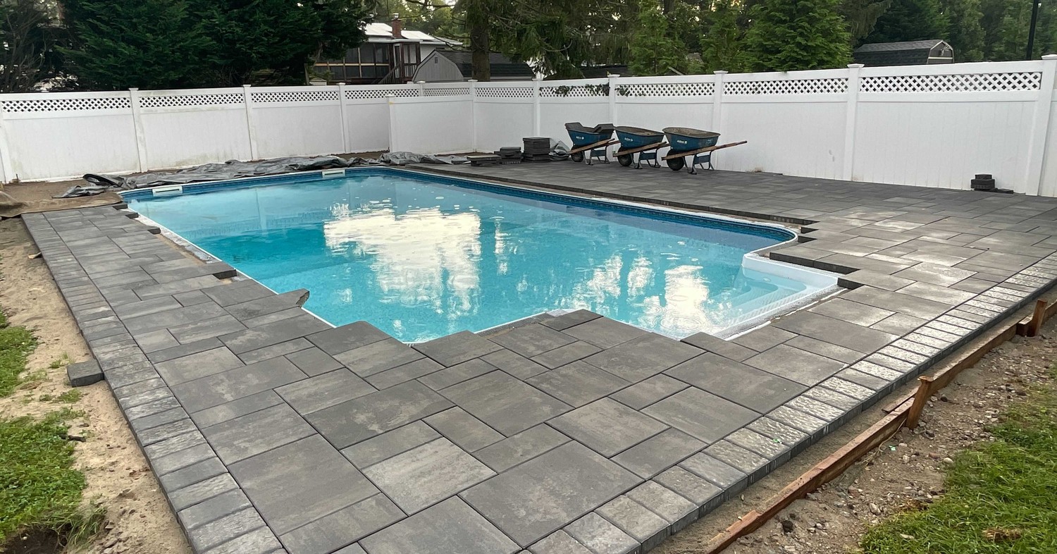 A patio near a pond demonstrating how to clean and maintain your paver patio