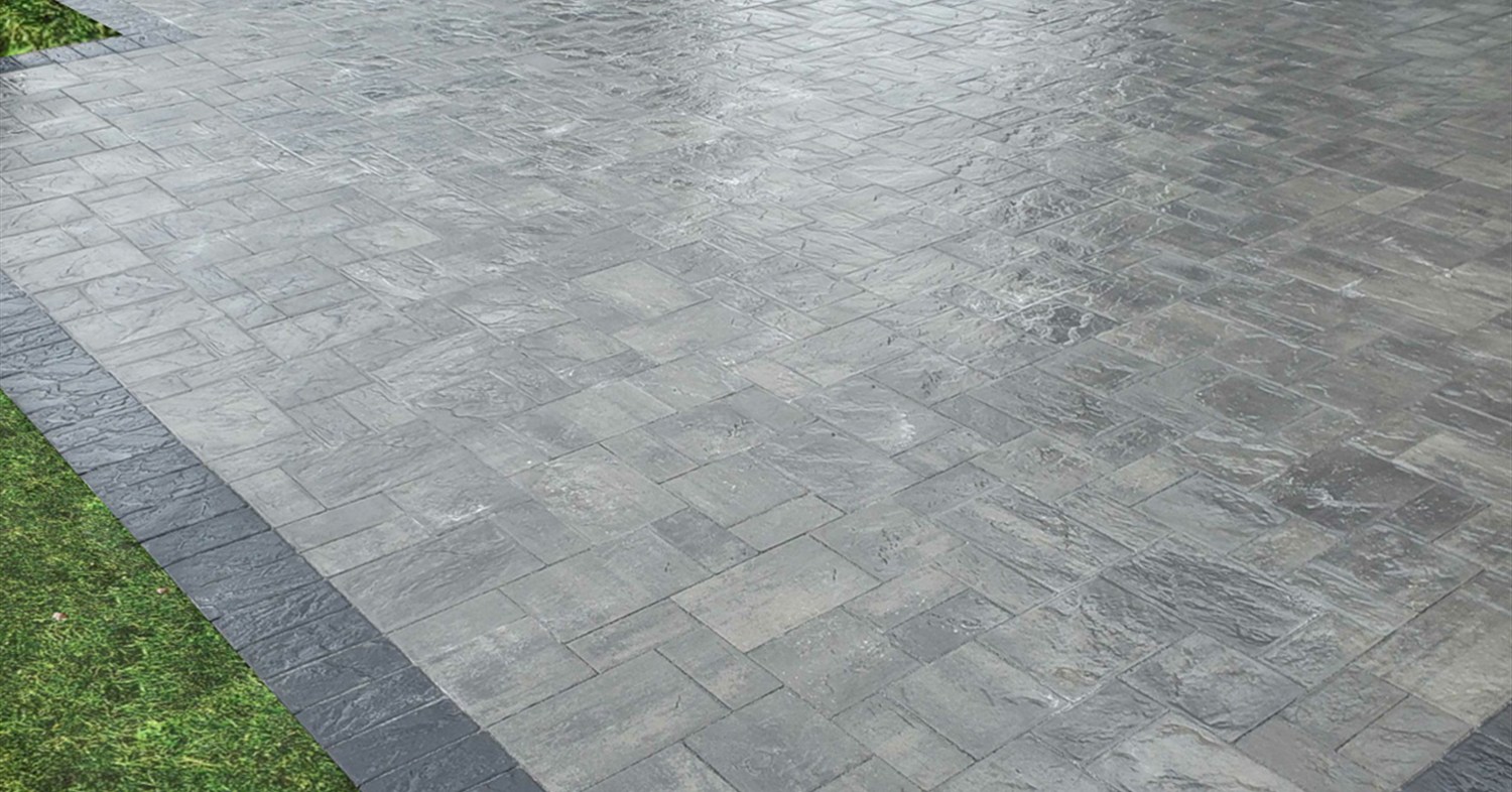 A textured grey paver patio surface ready for custom patio covers on Long Island