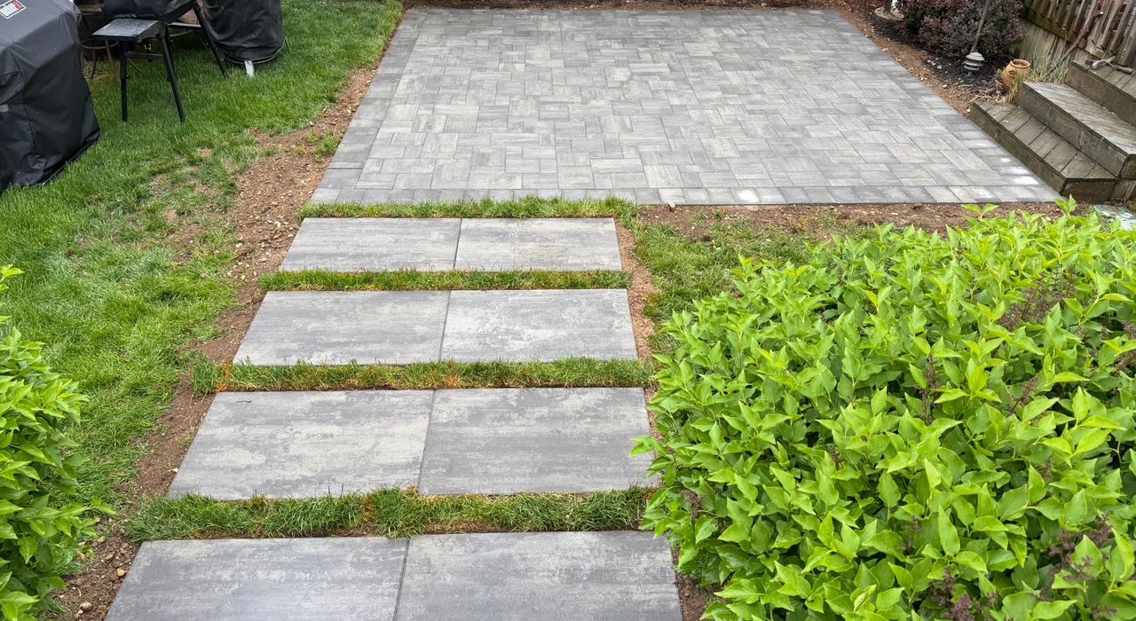 paver driveway installation process showing excavation, base compaction, drainage planning, and edge restraint